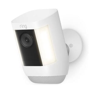 A white Ring security camera with an integrated light and speaker, mounted on a wall.