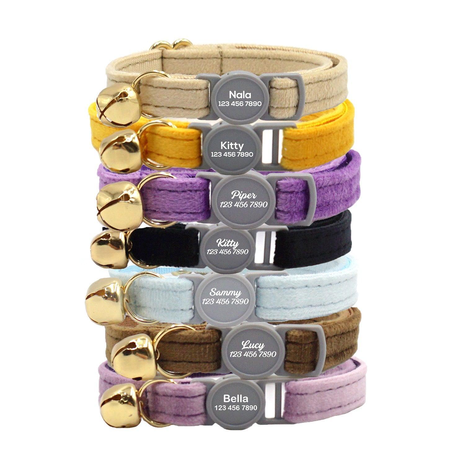 Seven colorful cat collars with bells, featuring engraved name tags showing pet names and a phone number.