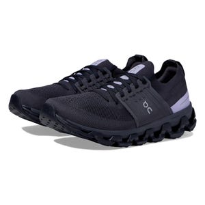 A pair of black athletic running shoes with white detailing on the heel.