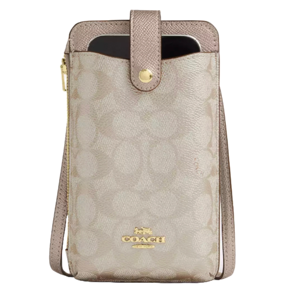 Coach Outlet Phone Crossbody in beige signature canvas with a gold logo, features a secure snap closure, zippered side compartment, and an adjustable strap for carrying.