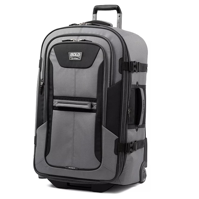 A gray wheeled duffel bag with a telescopic handle, featuring multiple compartments and zipper closures. It has side straps for additional security and is branded with \“Bold by Travelpro.\“