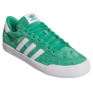 Green Adidas sneaker with white stripes, gold \“NORA\“ text, and white sole.