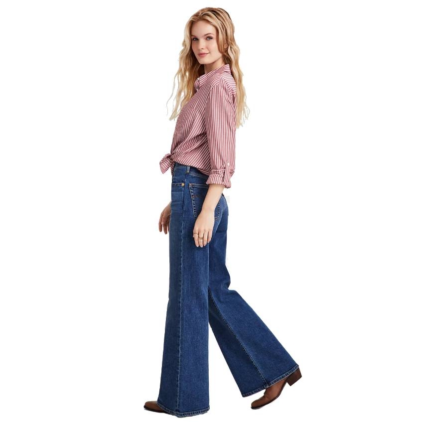 Levi's high-rise flare-leg jeans in dark blue denim with a fitted waist and flared hem, styled with a red and white striped shirt.