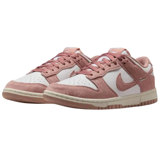 A pair of pink and white Nike Dunk low-top sneakers with suede accents and distinctive Nike branding on the side.