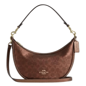 A brown Coach shoulder bag with a crescent shape, features the signature monogram pattern, gold-tone hardware, a detachable strap, and a leather tag.