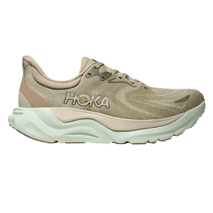 Hoka running shoe in beige and cream, featuring a cushioned sole and the brand's logo on the side.