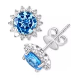 Blue gemstone stud earrings with a round cut, surrounded by small clear stones set in metal with a butterfly back closure.