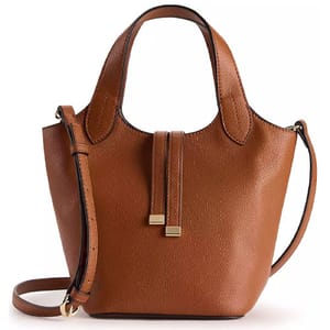 A brown leather handbag featuring a short handle, a detachable shoulder strap, and decorative metal accents.