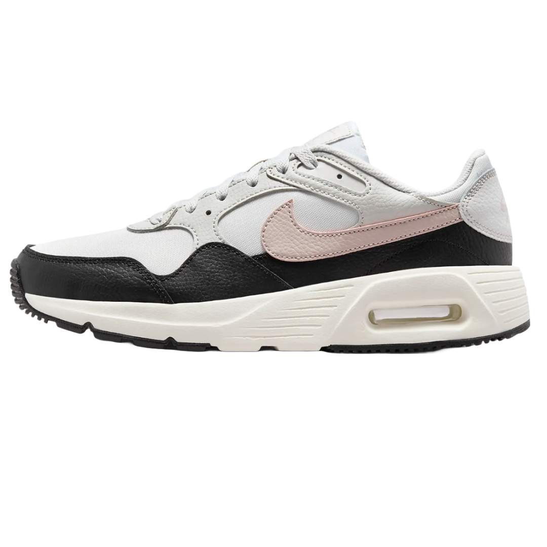 A pair of Nike sneakers with a white, black, and light pink color scheme, featuring a retro design with visible air cushioning in the midsole.