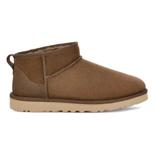 A brown ankle-height suede boot with a pull loop at the back and a light tan, textured sole.