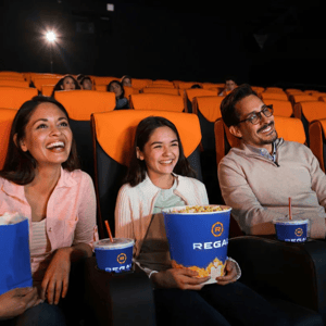 Regal Movie Tickets & Snacks include large buckets of popcorn with the Regal logo and cups with straws, all branded with the Regal logo.