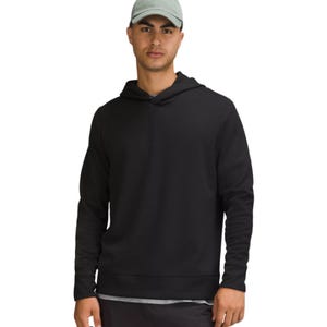 Lululemon Shift Stitch Men's Hoodie is a stylish, lightweight black hoodie made from textured fabric. It features a relaxed fit with a simple design, ideal for casual wear.