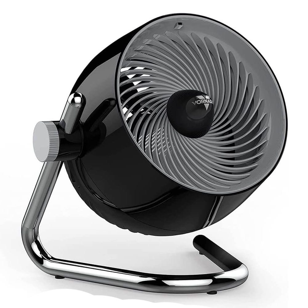 A black Vornado fan with a chrome stand, featuring a spiral vent design and an adjustable tilt mechanism.