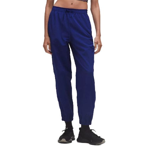 Blue athletic pants with an elastic waistband and cuffs, worn with black sneakers.