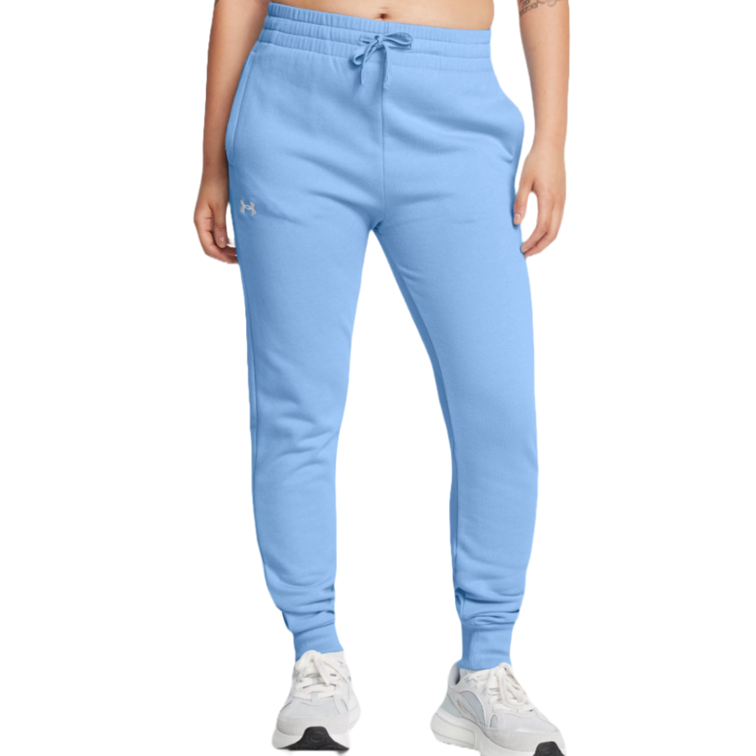 Light blue Under Armour joggers featuring a drawstring waistband, side pockets, and ribbed cuffs, paired with white sneakers.