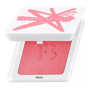 Fenty Beauty compact featuring a pink blush with a white lid marked by a pink \“X\“.