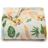 A soft, folded blanket featuring a playful lion cub and colorful leaves in a jungle-themed design.