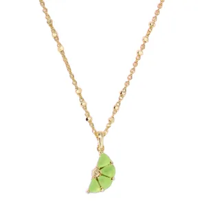Gold necklace featuring a green crescent-shaped pendant with a gem accent and an intricate chain design.