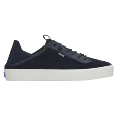 A navy lace-up sneaker with a white sole, featuring a breathable mesh upper and a small logo tag on the side.