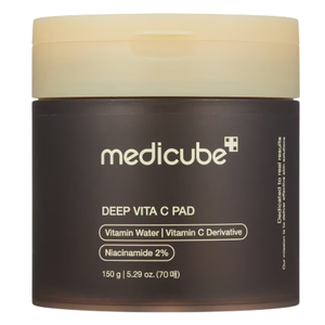 Medicated skincare jar labeled \“medicube Deep Vita C Pad\“ containing Vitamin Water, Vitamin C Derivative, and 2% Niacinamide; 150 g (5.29 oz) capacity with 70 pads.