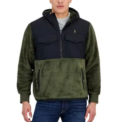 A green and black jacket featuring a plush sherpa design with a hood, dual chest pockets, and a zipper closure. Suitable for cold weather, paired with jeans.