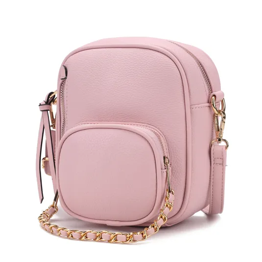 A pink faux leather crossbody bag features a compact design with a small front pocket, gold chain strap, and zipper closure.