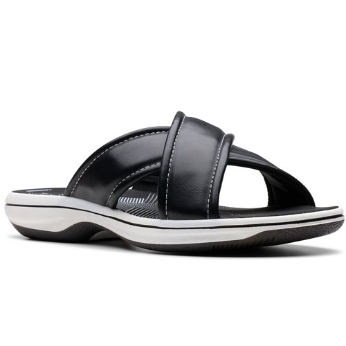 A black and white slide sandal featuring crisscross straps and a cushioned footbed designed for comfort.