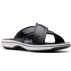 A black and white slide sandal featuring crisscross straps and a cushioned footbed designed for comfort.