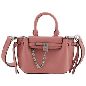 A small pink Michael Kors crossbody bag features top handles, a silver chain detail, a crossbody strap, and a lock charm.