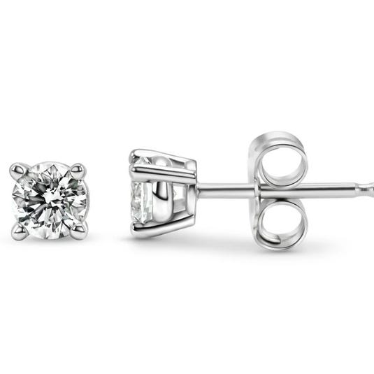 A pair of solitaire diamond stud earrings set in a four-prong metal setting with butterfly backs.