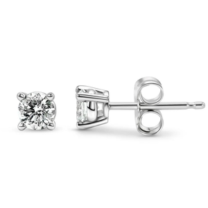 A pair of solitaire diamond stud earrings set in a four-prong metal setting with butterfly backs.
