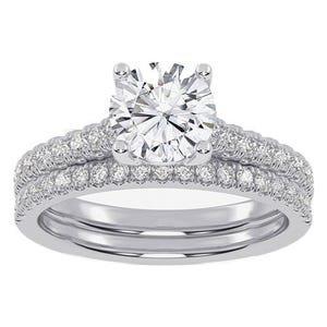 A silver engagement ring set with a large central diamond and smaller diamonds encircling the band.