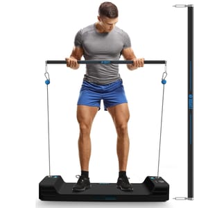 A man is using a Smart Cable Home Gym that features a compact base with cables and a long bar for resistance training. The gym is designed for various exercises and saves space, incorporating digital weight settings.