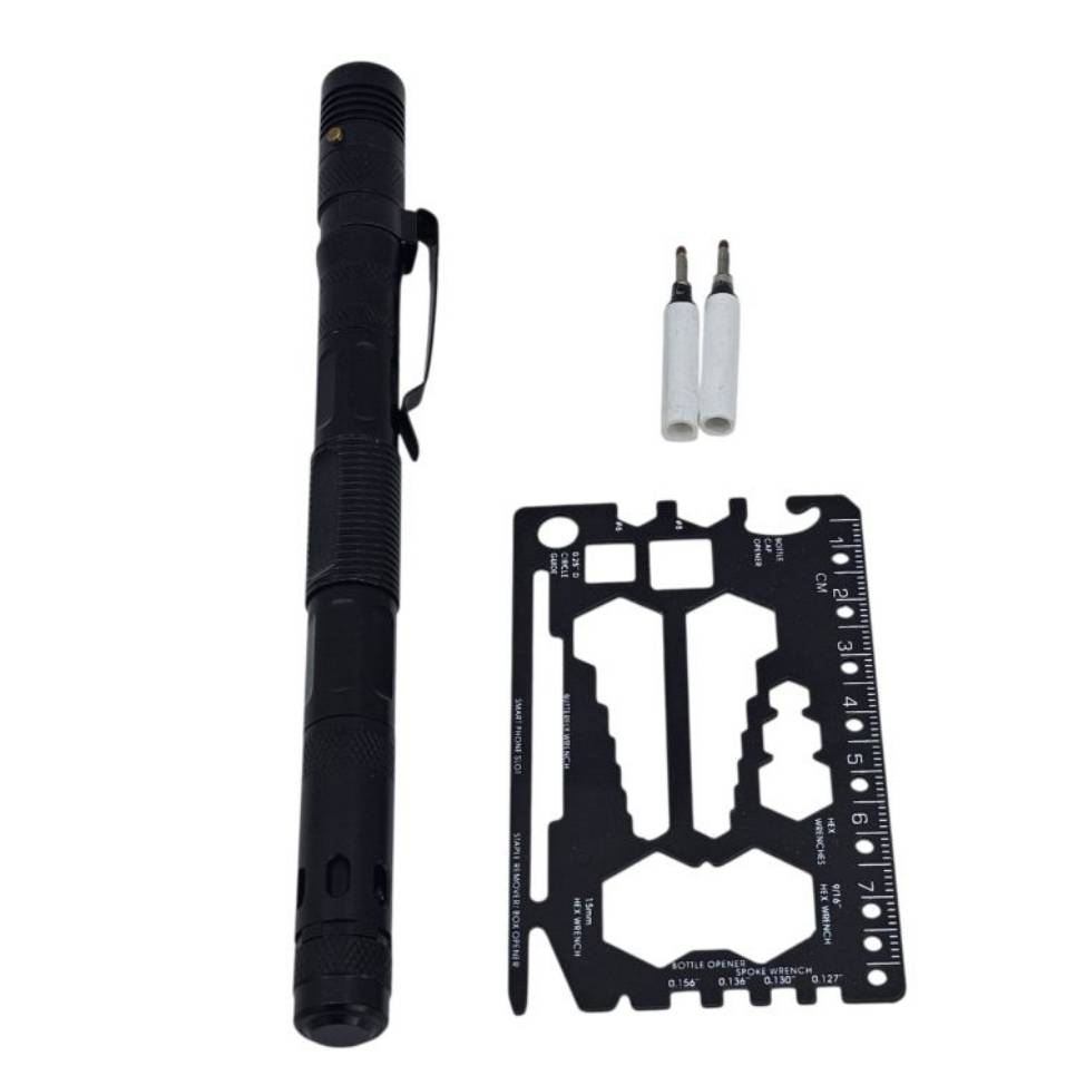 A black tactical pen with a clip, two white pen cartridges, and a black multi-tool card featuring various cutouts and a ruler.