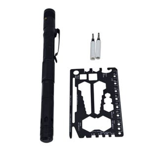 A black tactical pen with a clip, two white pen cartridges, and a black multi-tool card featuring various cutouts and a ruler.