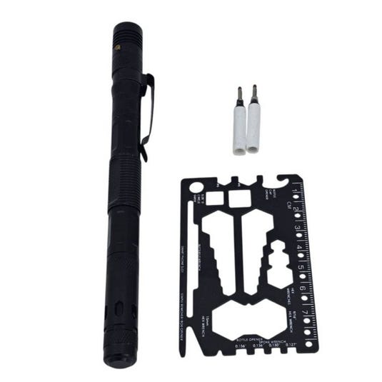 A black tactical pen with a clip, two white pen cartridges, and a black multi-tool card featuring various cutouts and a ruler.