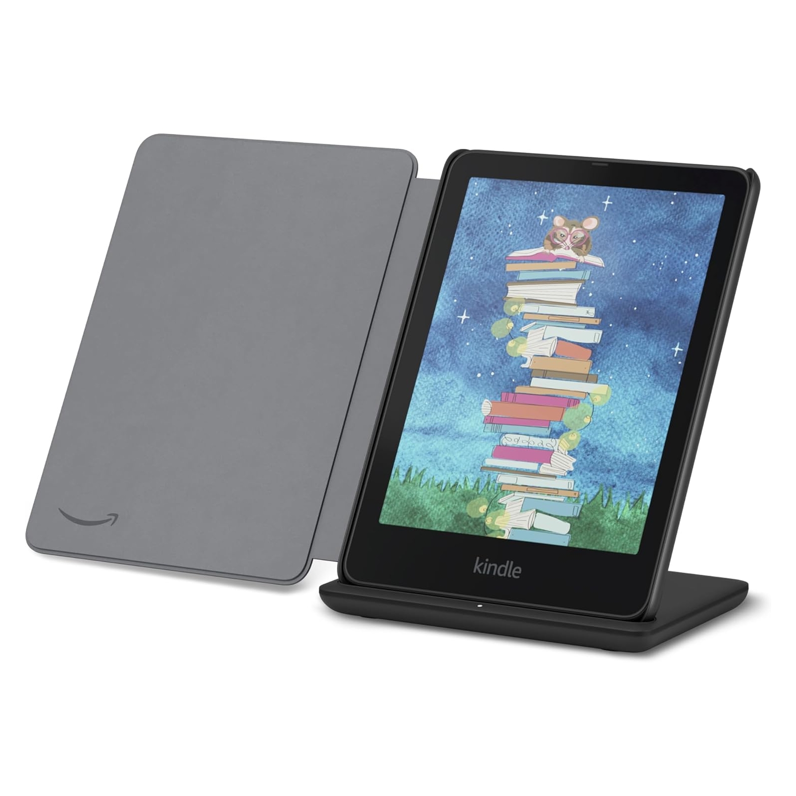 Kindle e-reader with a cover, displayed on a wireless charging stand. The screen shows an illustration of a mouse atop a stack of books against a starry background.