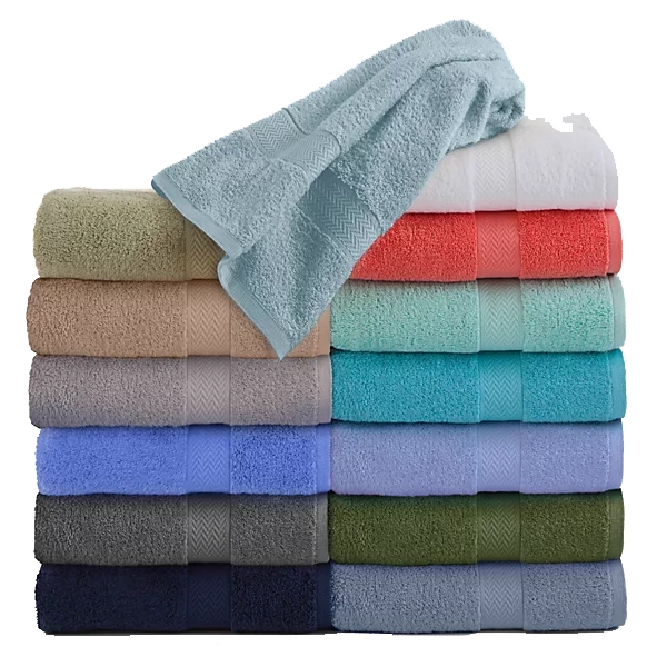 A stack of colorful towels in various shades, including pastels and dark tones, with one towel draped on top. Each towel features a subtle geometric pattern.