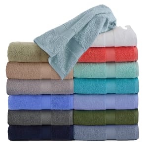 A stack of colorful towels in various shades, including pastels and dark tones, with one towel draped on top. Each towel features a subtle geometric pattern.