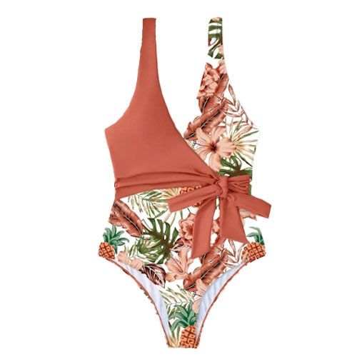Asymmetrical one-piece swimsuit with a solid rust-colored top and a floral patterned bottom, featuring a tie detail at the waist for added style.