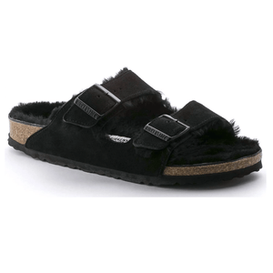 A black suede sandal with a cork sole and two adjustable straps, featuring a fuzzy interior lining.