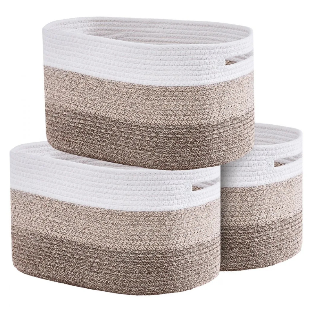 Three woven rope storage baskets in a stack, featuring white, beige, and brown tones with built-in handles.