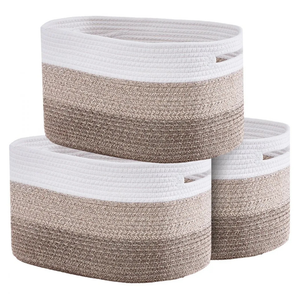 Three woven rope storage baskets in a stack, featuring white, beige, and brown tones with built-in handles.