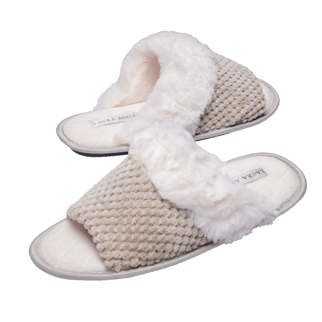 Laura Ashley Plush Slippers are open-toed with a textured, beige fabric and white faux fur trim, offering a cozy and comfortable design.
