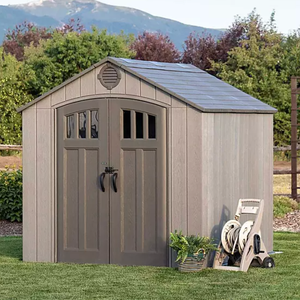 Suncast 8' Storage Shed features a double-door design with arched windows, shingle-style roof, and neutral color. A garden hose reel and potted plant are placed nearby, highlighting its use in a backyard setting.