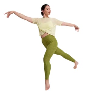 A woman is wearing a light yellow cropped top and olive green leggings.