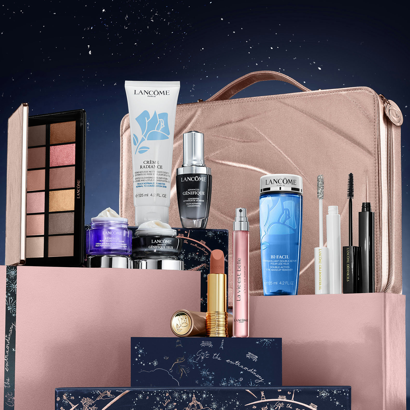 A collection of Lancôme beauty products including skincare creams, serums, makeup items, and a rose gold cosmetic bag.