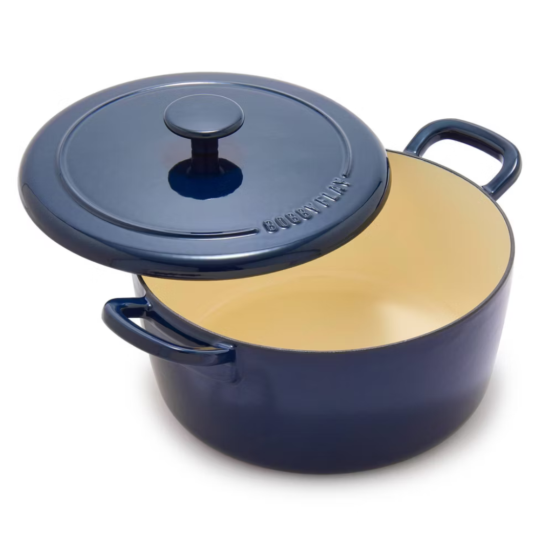 A blue enameled cast iron Dutch oven with handles and a matching lid, featuring an off-white interior.