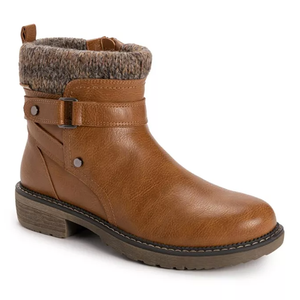 Muk Luks Garland Gina Booties are brown faux leather ankle boots with a textured knit cuff, featuring a decorative buckle and side strap. They have a low heel and sturdy sole, offering a casual yet stylish look.