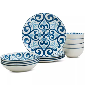 A dinnerware set featuring blue and white plates and bowls with ornate patterns. The design includes intricate, symmetrical blue swirls on a white background.